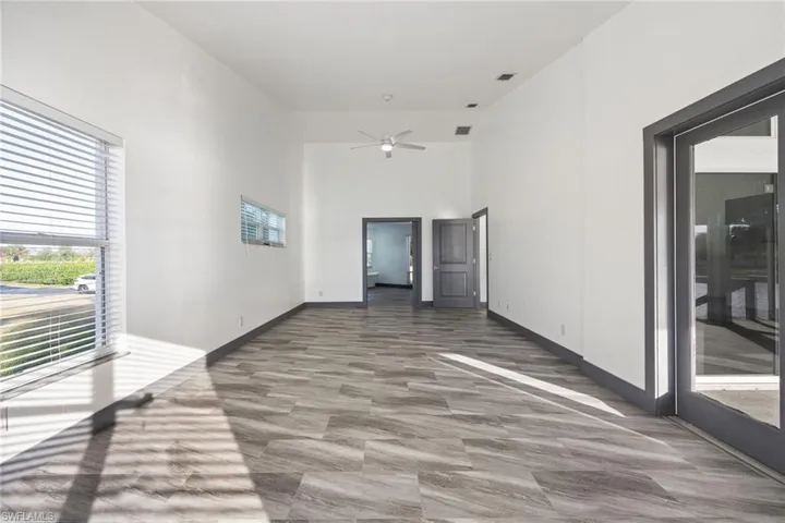 Spare room featuring a high ceiling and a ceiling fan