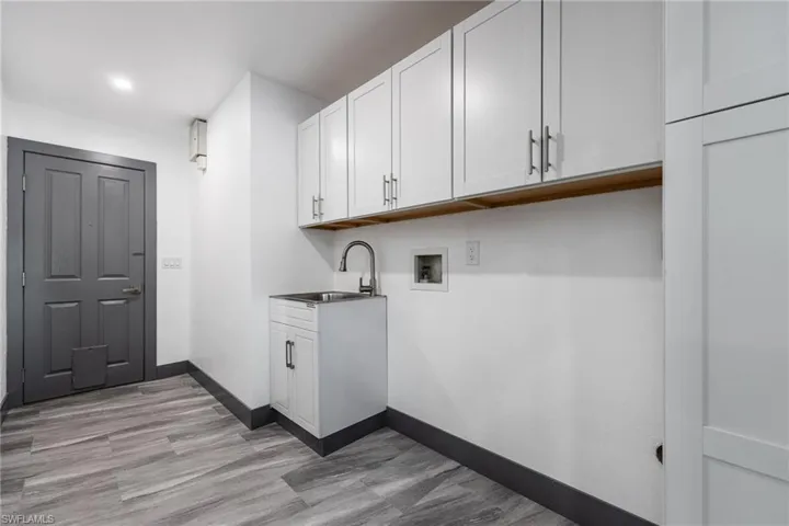 Laundry room featuring washer hookup and cabinet space