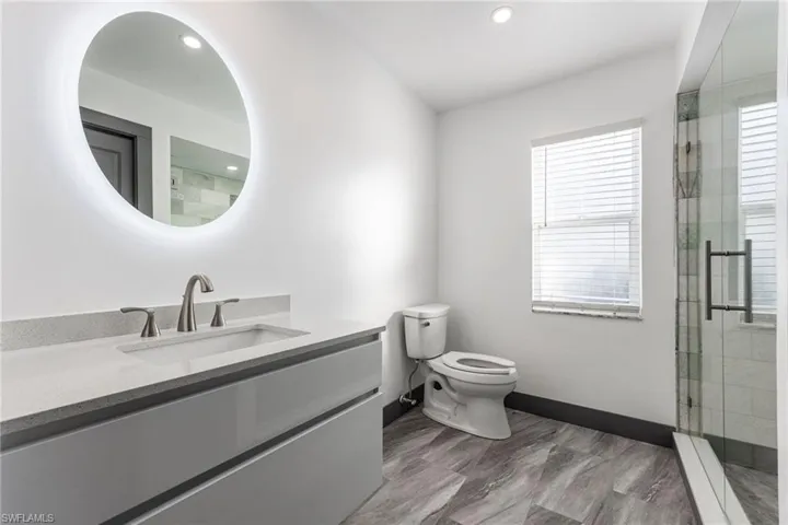 Bathroom with vanity and a stall shower