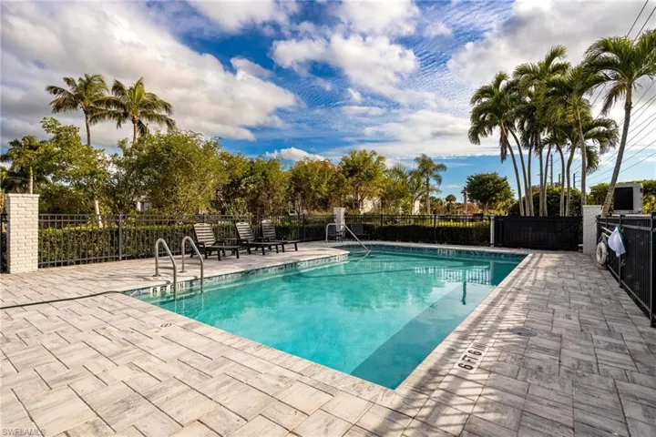 Community pool with a patio