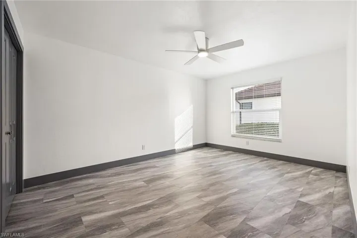 Spare room featuring baseboards and a ceiling fan