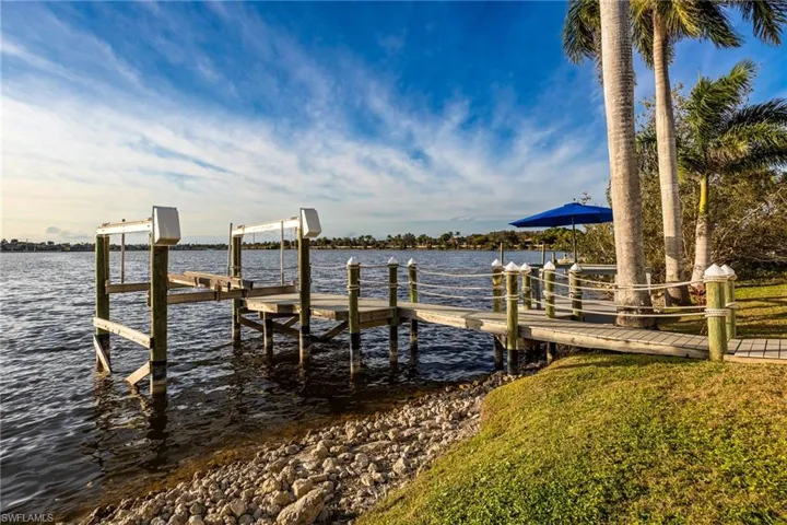 Dock featuring boat lift and a water view