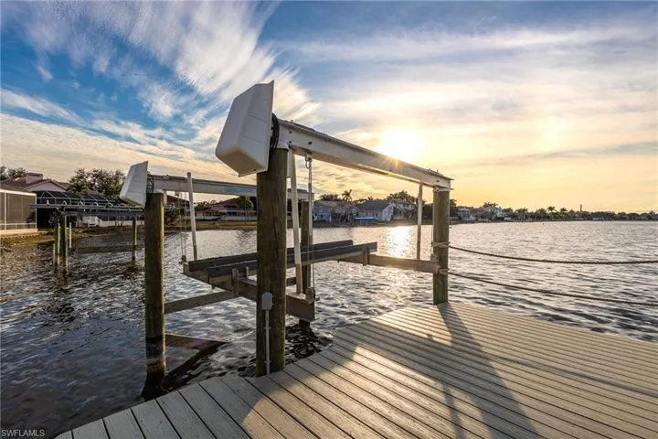 Dock featuring boat lift and a water view