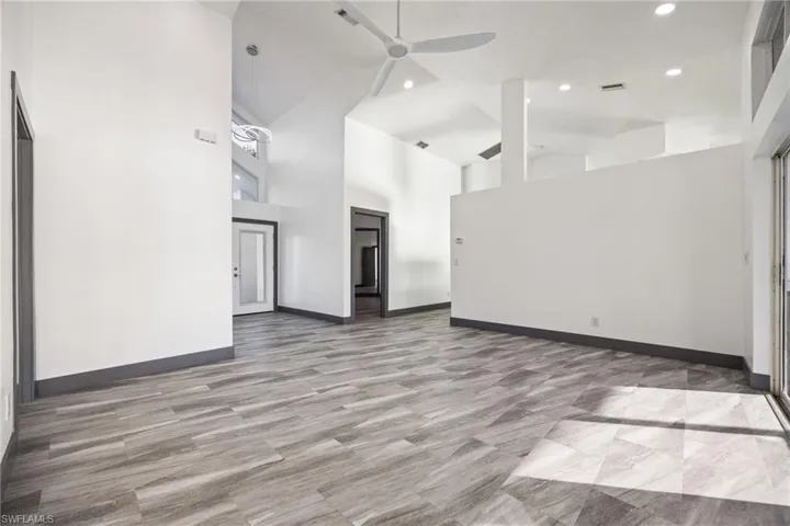 Spare room with high vaulted ceiling, ceiling fan, and recessed lighting