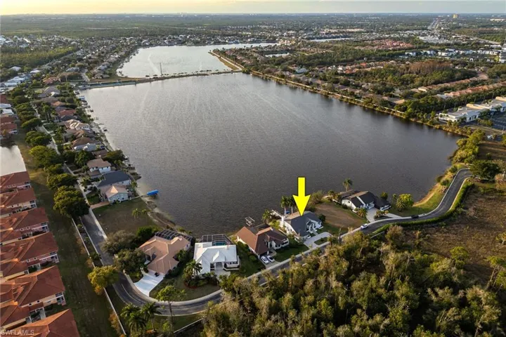 Aerial view of property's location with nearby suburban area and a nearby body of water