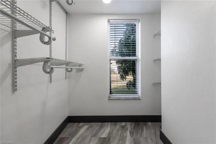 Spacious closet with light wood-type flooring