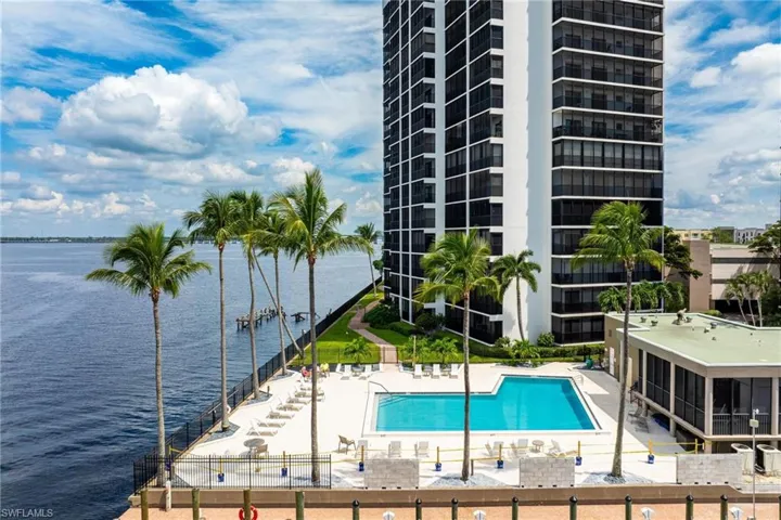View of pool with a patio and a water view
