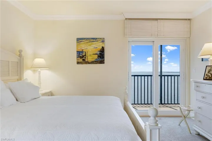 Master bedroom featuring access to outside and ornamental molding