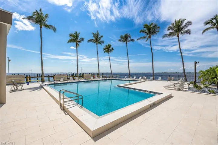 View of pool featuring a water view and a patio area