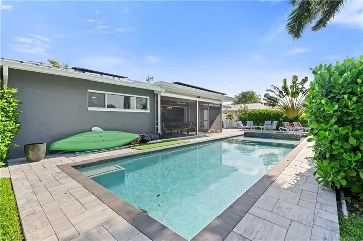 Pool with a sunroom and a patio - Virtually Edited Image