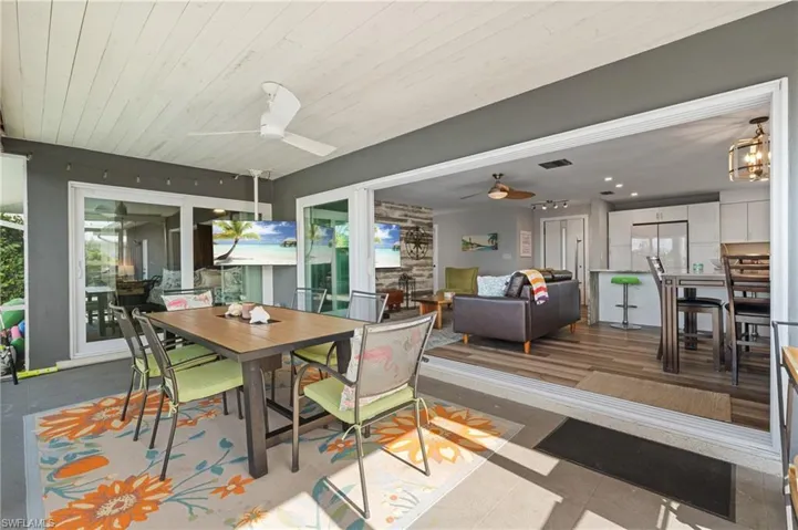 Dining room with visible vents, ceiling fan, and a healthy amount of sunlight  - Virtually Edited Image