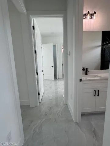 Motherc- in - Low's room entrance, Corridor with light marble finish floors.