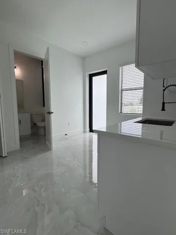 Mother - in - Low's Kitchen and living area with corner door.