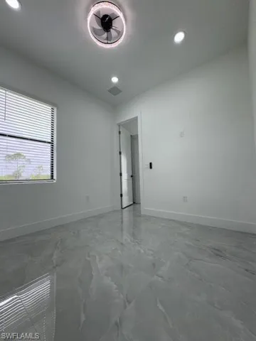 Unfurnished room with recessed lighting and light marble finish floors