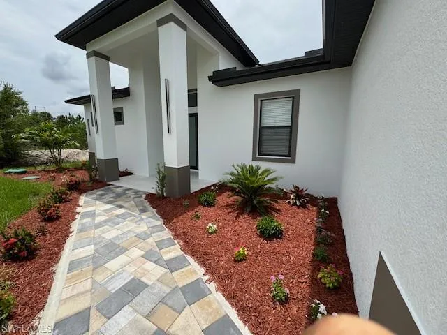 Doorway to property with stucco siding
