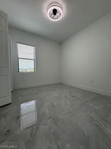 full view's Unfurnished room with baseboards and unfurnished bedroom marble look tile flooring