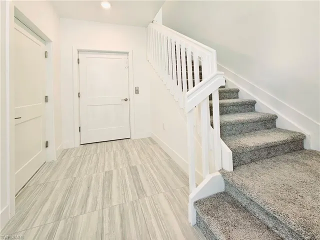 Stairs featuring baseboards and recessed lighting