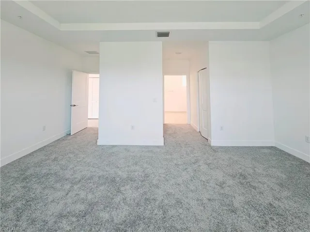Unfurnished room featuring carpet flooring and baseboards