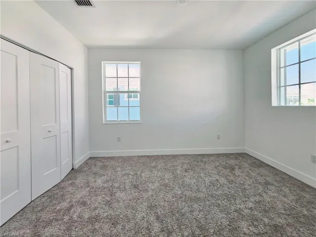 Unfurnished bedroom with carpet, baseboards, and a closet