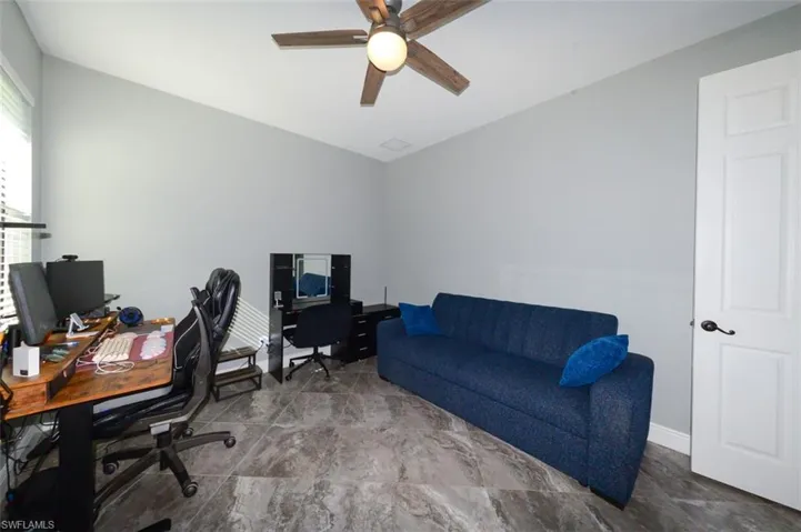 Office space featuring a ceiling fan and baseboards