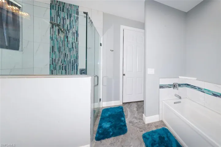 Bathroom with a garden tub and a stall shower