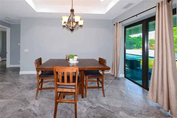 Dining space with a chandelier and recessed lighting