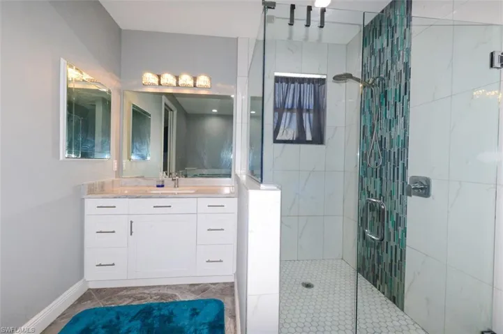 Bathroom with walk in shower and vanity