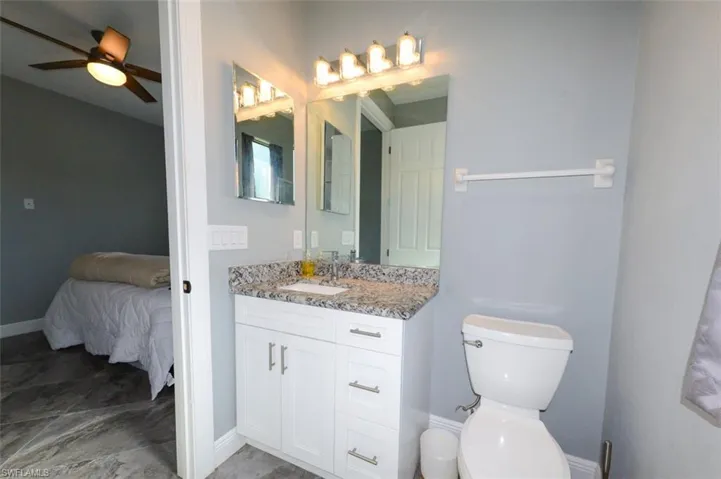 Ensuite bathroom featuring vanity and a ceiling fan