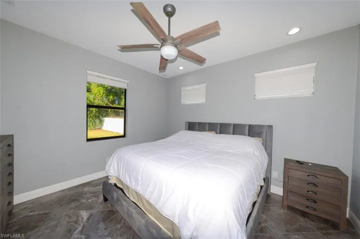 Bedroom with a ceiling fan and recessed lighting