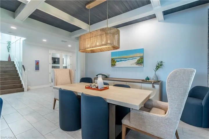 Dining area featuring a coffered ceiling with wood-finish planks, recessed lighting, and a woven pendant light fixture