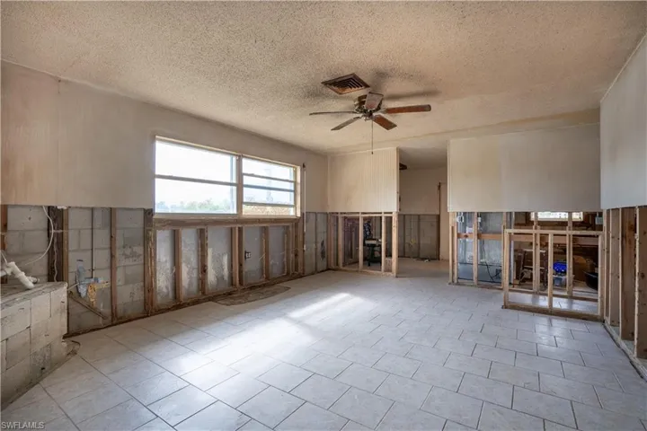Unfurnished room featuring ceiling fan and a textured ceiling