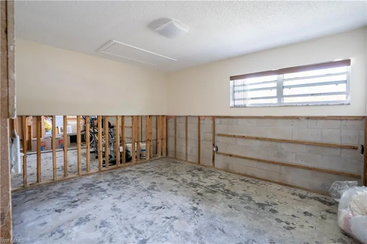 Unfurnished room featuring a textured ceiling