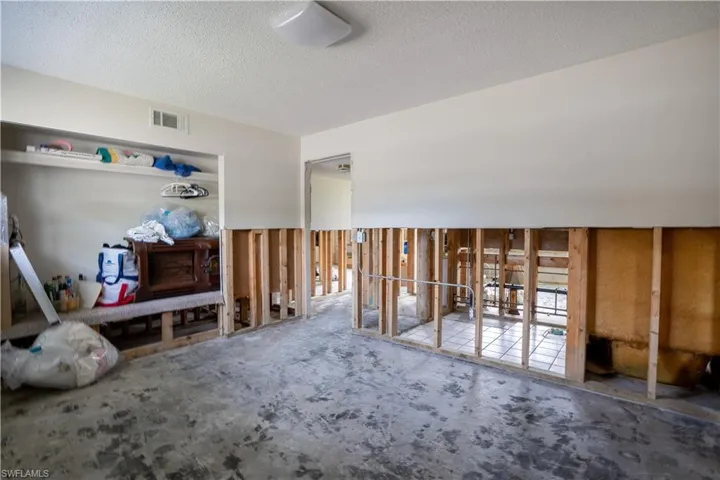 Miscellaneous room with carpet and a textured ceiling