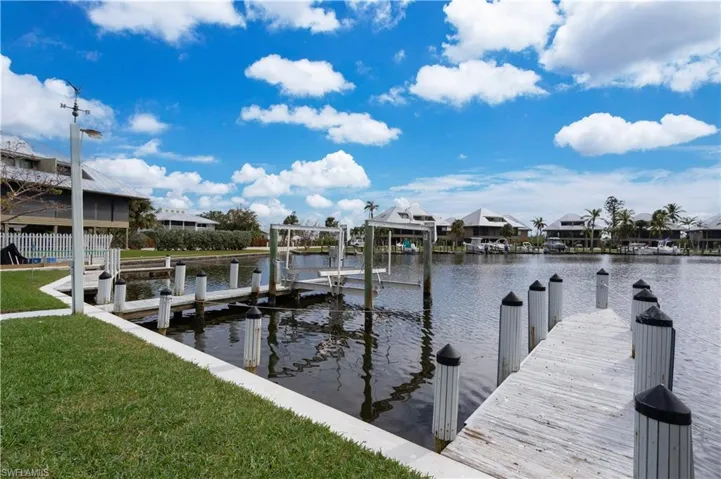 Dock area featuring a yard and a water view
