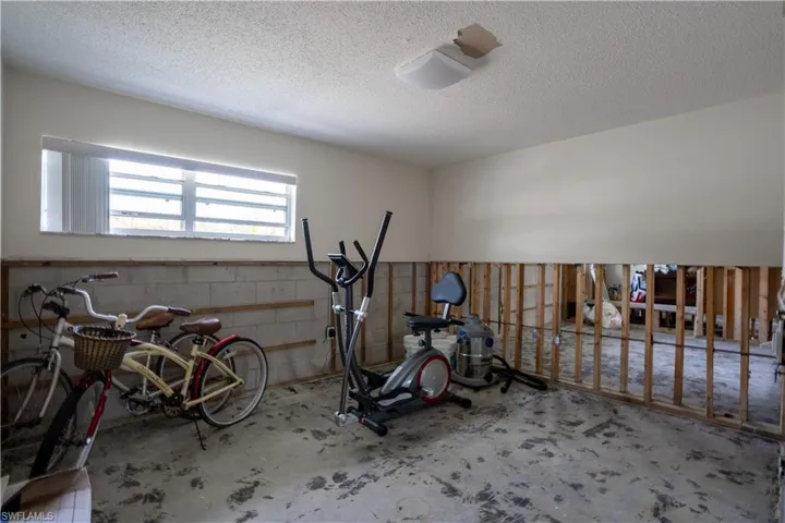 Workout area featuring a textured ceiling