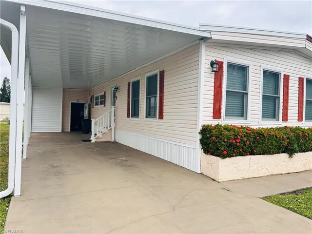 View of side of property with a carport