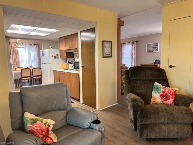 Living room with hardwood / wood-style flooring