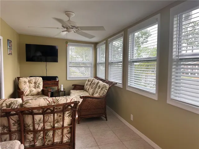 Bedroom with ceiling fan and light tile patterned floors