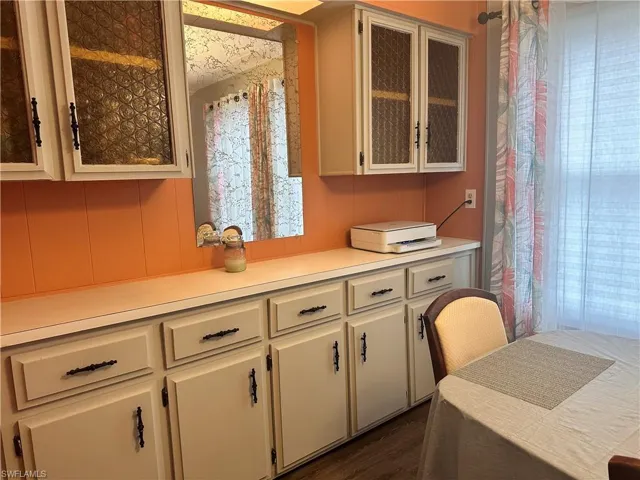 Kitchen featuring white cabinets and dark hardwood / wood-style floors
