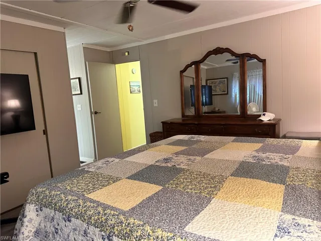 Bedroom with ceiling fan and crown molding