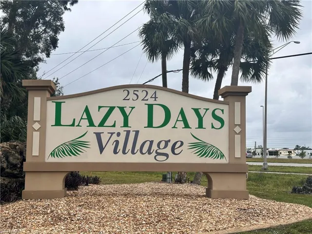 Community / neighborhood sign with a water view