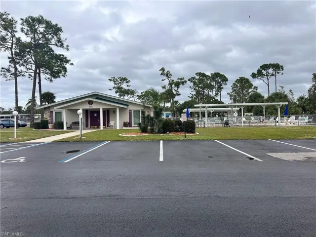 View of parking with a lawn