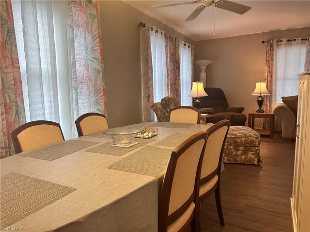 Dining room with ceiling fan and wood-type flooring