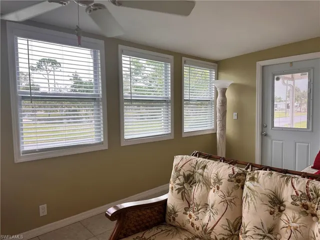 Sitting room featuring ceiling fan and tile patterned flooring