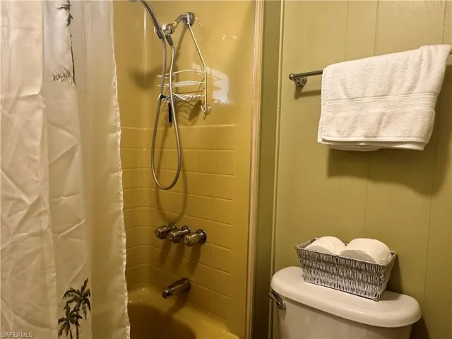 Bathroom featuring shower / bath combo with shower curtain and toilet