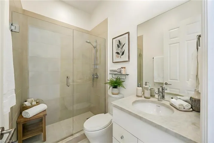 Full bathroom featuring vanity and a stall shower