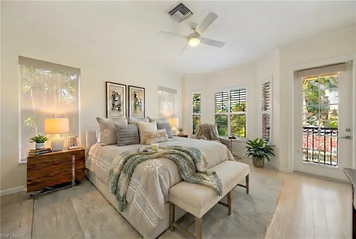 Bedroom with access to exterior, light wood-type flooring, ornamental molding, and ceiling fan