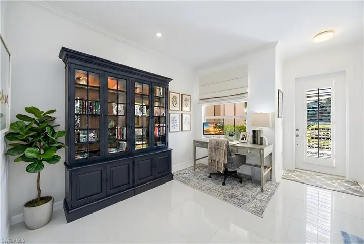 Tiled home office featuring ornamental molding