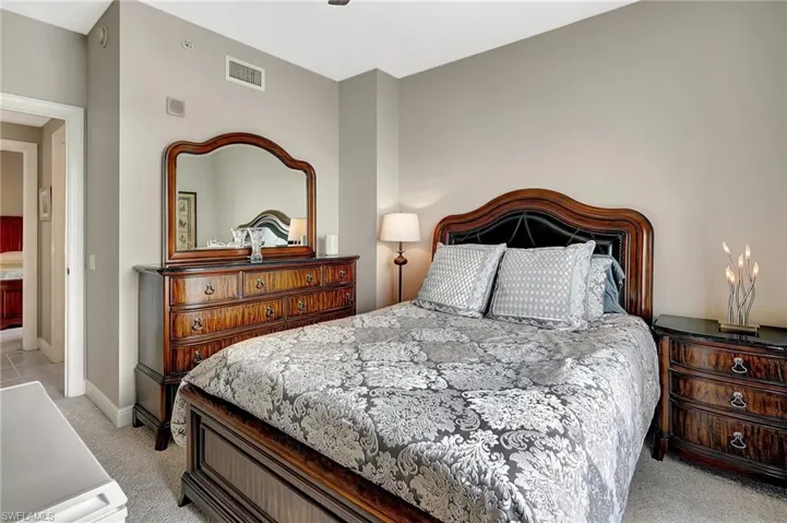 Bedroom featuring light carpet