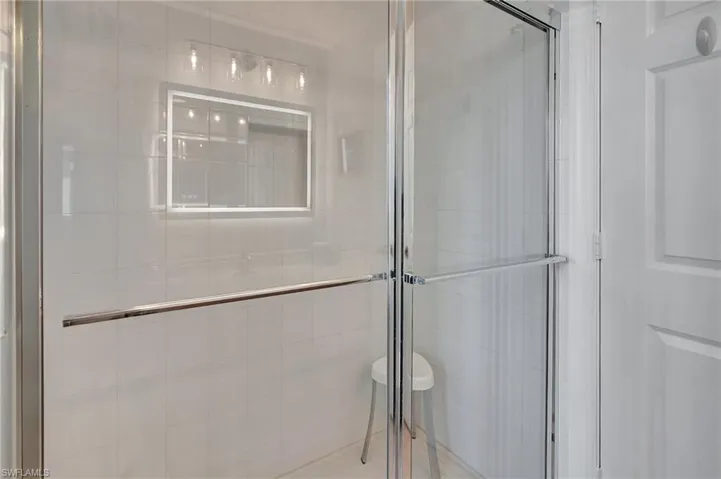 Bathroom featuring tile walls and walk in shower